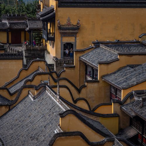 Free Aerial view of ornate Chinese temple roofs with yellow walls. Stock Photo