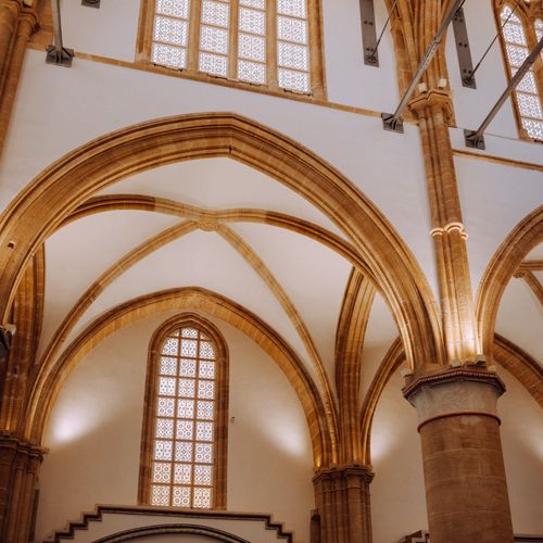 Free Stunning Gothic architecture showcasing intricate archways and detailed windows inside a historic church. Stock Photo
