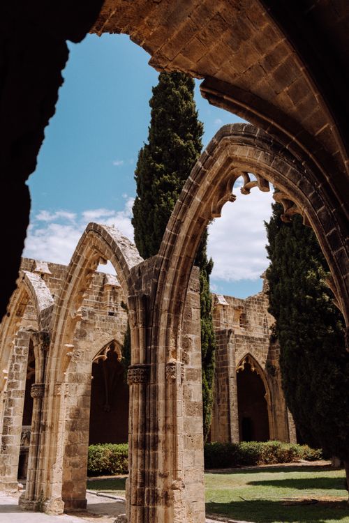 Free Explore the Gothic arches of ancient abbey ruins under a vibrant blue sky. Stock Photo