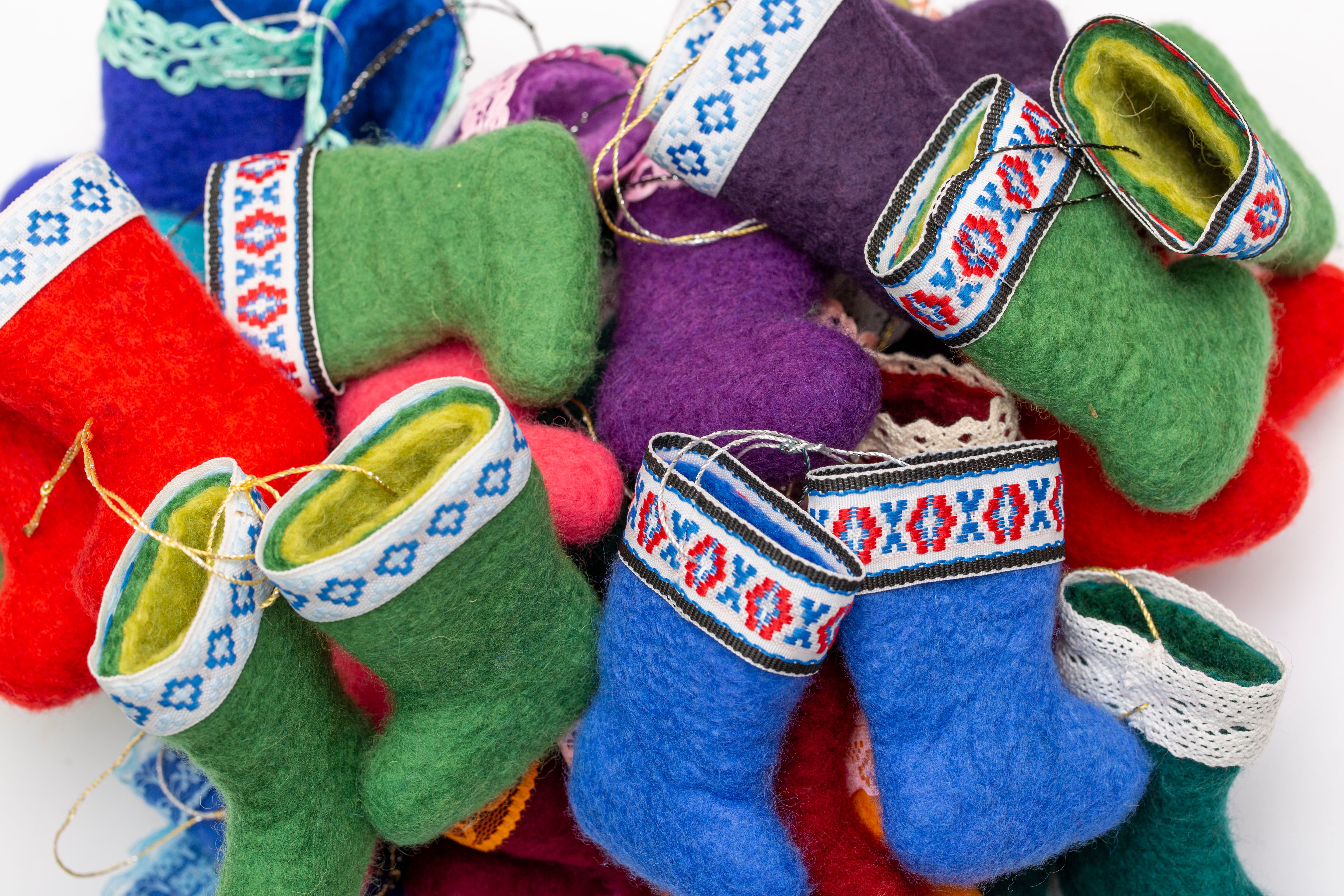A collection of colorful handmade felt boots with intricate embroidery, ideal for decoration or crafts.