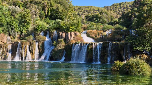 Breathtaking waterfalls cascade amidst lush greenery at Krka National Park.