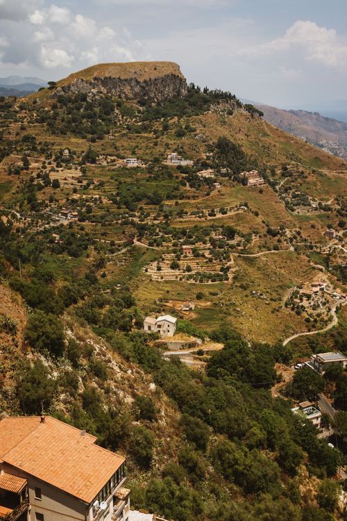 Free Scenic aerial view of the lush hillside countryside of Sicily, Italy, under a bright day. Stock Photo