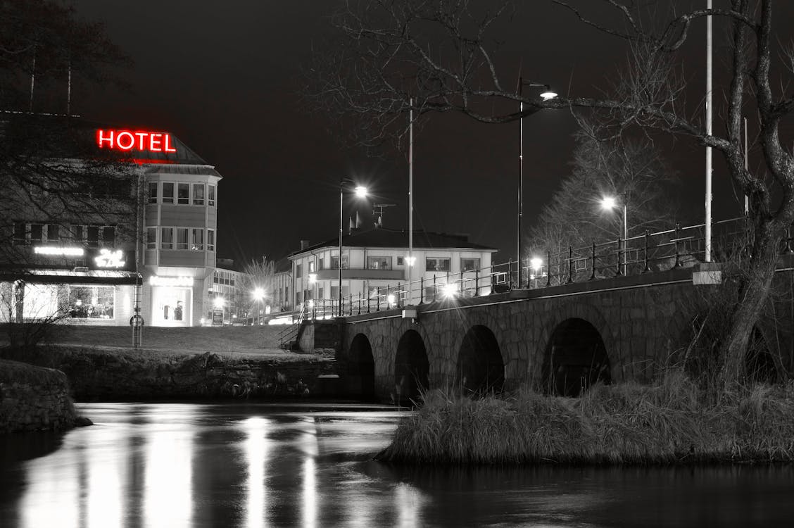 Grayscale Photo of Hotel Near River