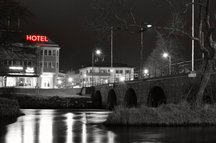 Grayscale Photo Of Hotel Near River