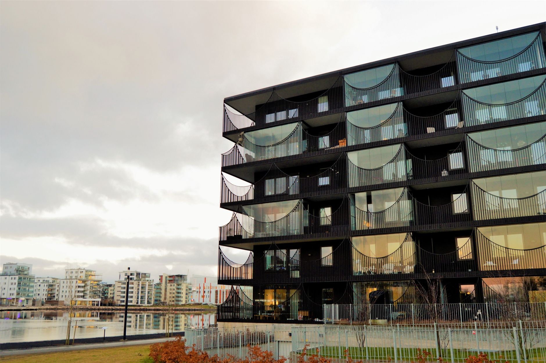 Contemporary apartment building with unique facade by a waterfront in Norrtälje, Sweden.