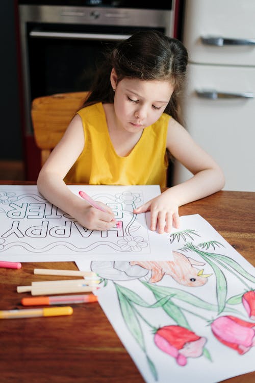 Girl in Yellow Tank Top Drawing on White Paper