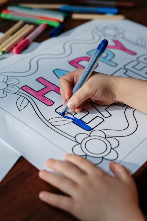 Kid Coloring Happy Easter on White Paper