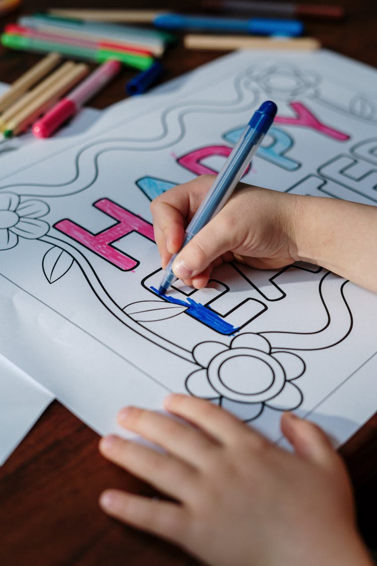 Kid Coloring Happy Easter On White Paper