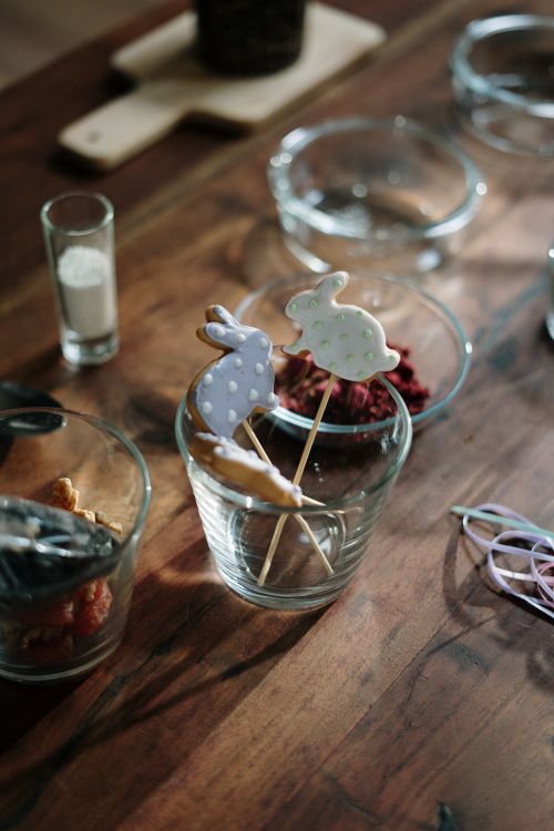 Free Charming Easter bunny cookies in glasses on a wooden table, perfect for festive decoration. Stock Photo