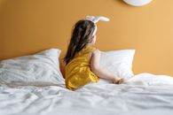 Girl in Yellow Dress Lying on Bed