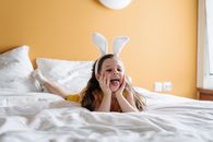 Girl in Yellow Shirt Lying on Bed