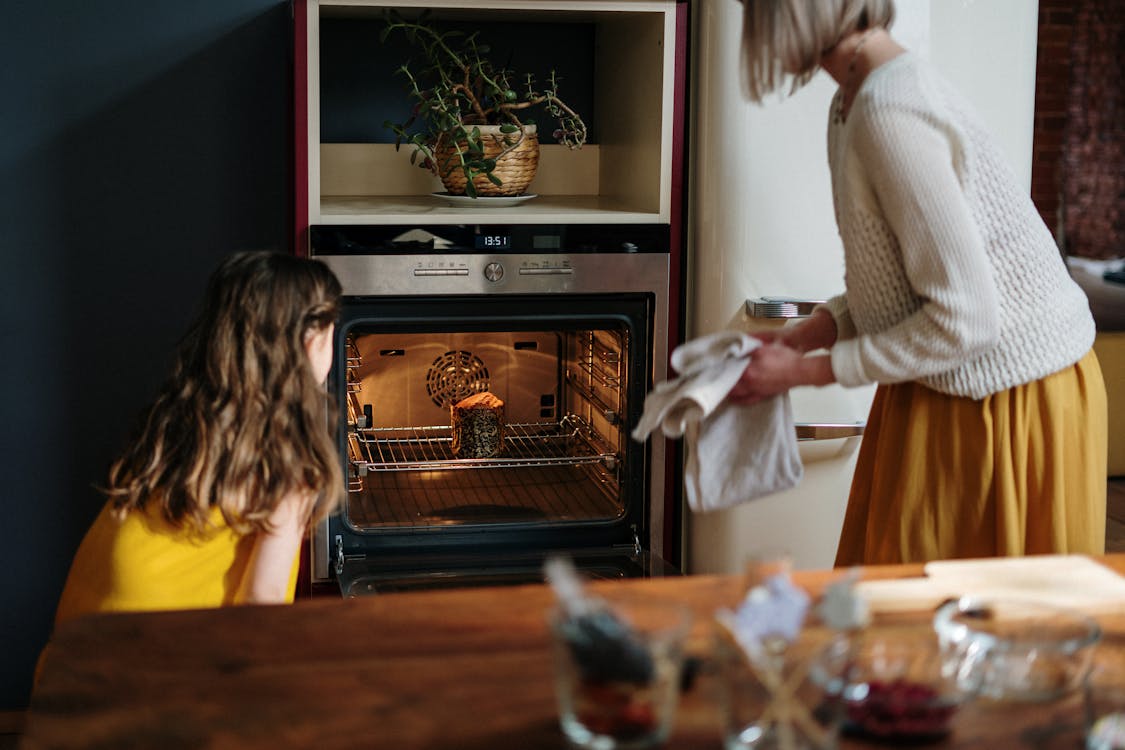 Free Mom and Daughter Baking a Cake Stock Photo