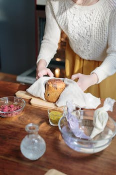 A woman decorates an Easter cake at home with vibrant ingredients on a sunny day.