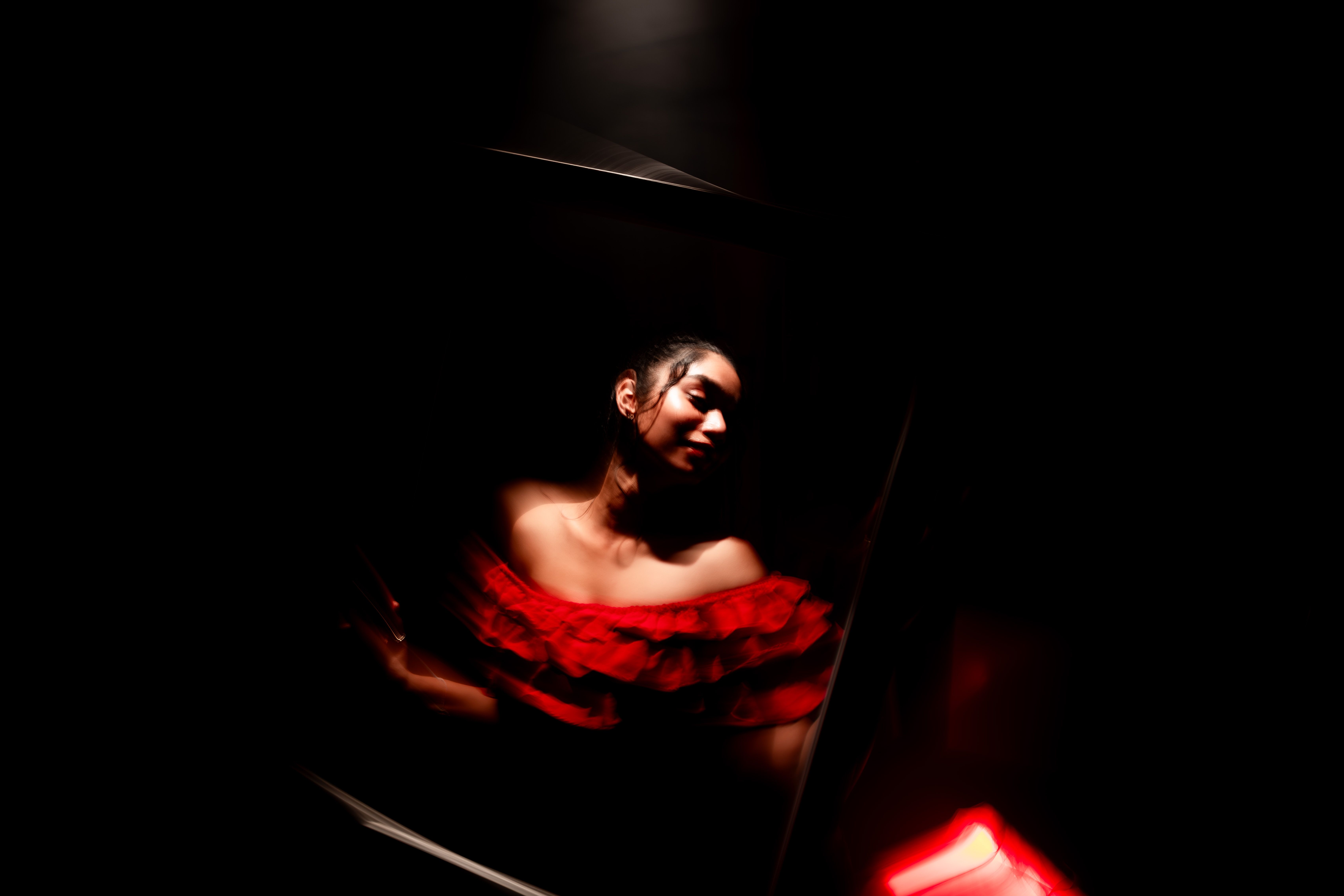 Photographer adjusting a portrait session in a warm studio