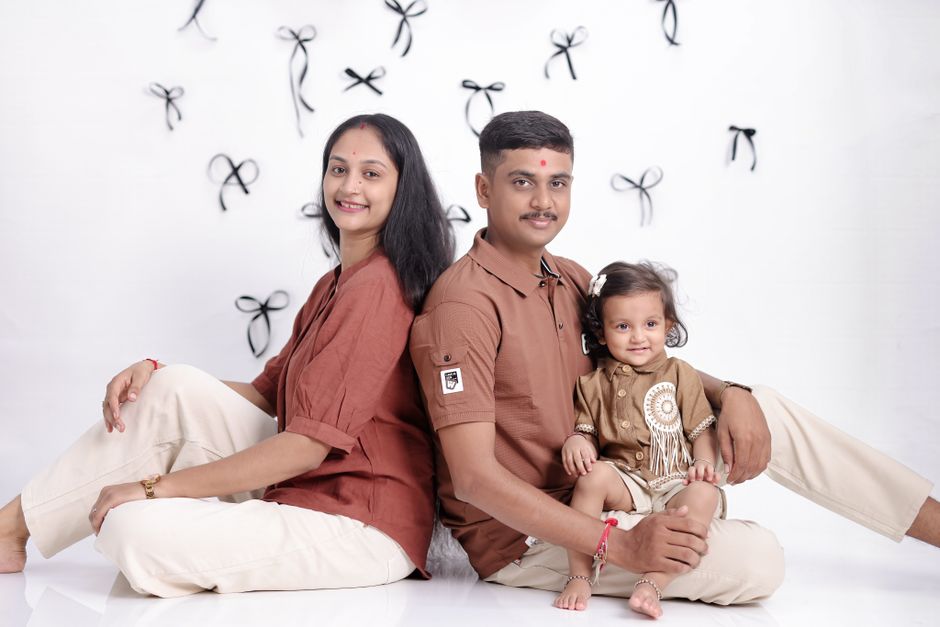 Photo by Krishna Kids Photography on Pexels Charming studio portrait of a happy family with a baby, sitting together against a decorative background. - Photo by Krishna Kids Photography on Pexels