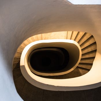 Artistic view of a spiral staircase in Warszawa, capturing unique architectural lines and shadows.（イメージ）