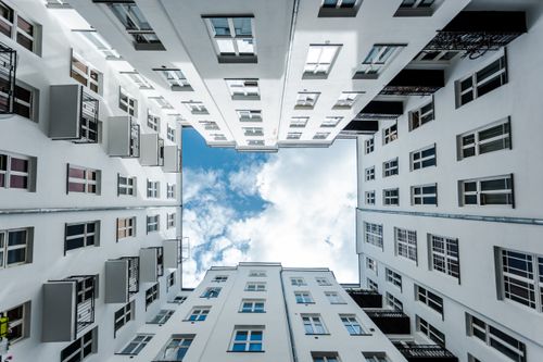Free Dramatic view of a Warsaw apartment courtyard looking towards a blue sky. Stock Photo