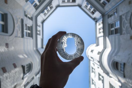 A creative perspective view of a Wrocław courtyard through a handheld lens showing architectural details.