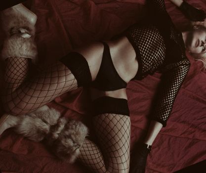 Woman in Black Brassiere and Black Panty Lying on Red Bed