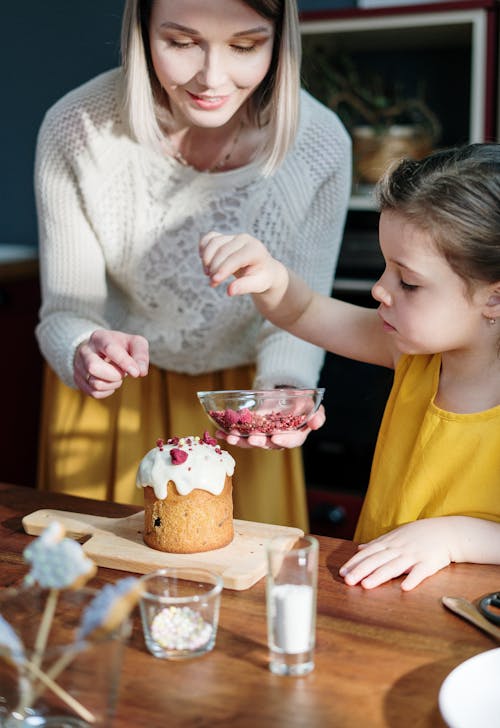 Girl in Yellow Shirt Holding Brown Cake