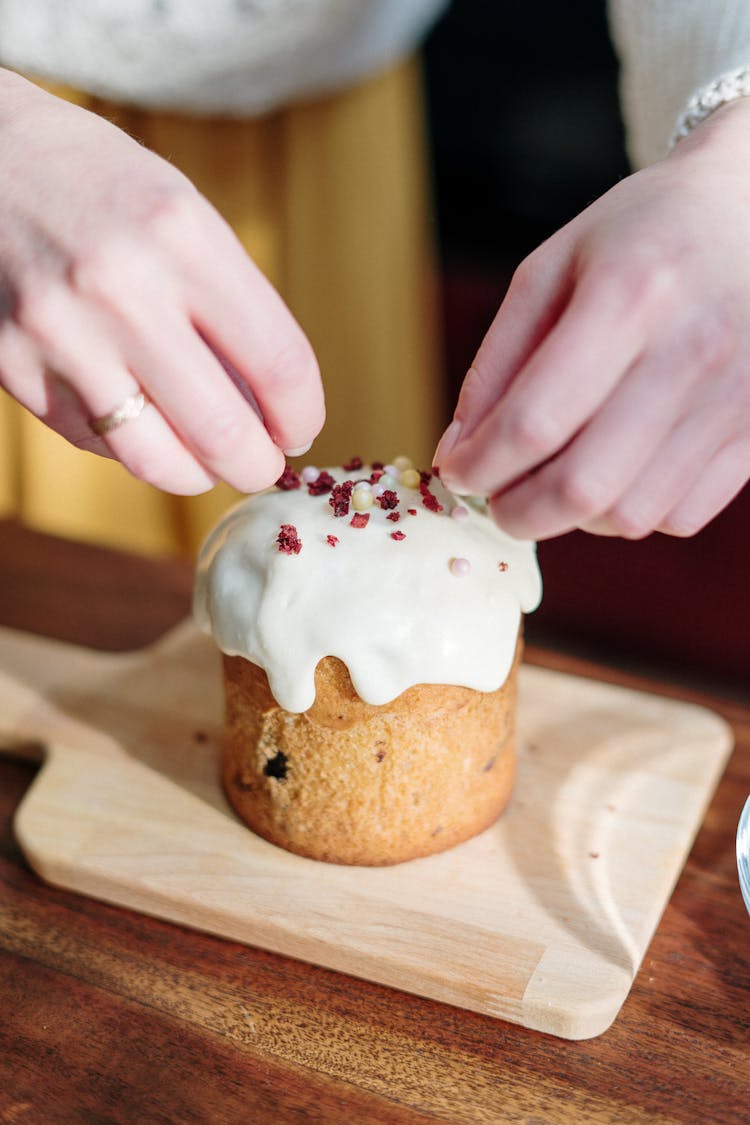 Person Decorating A Cake