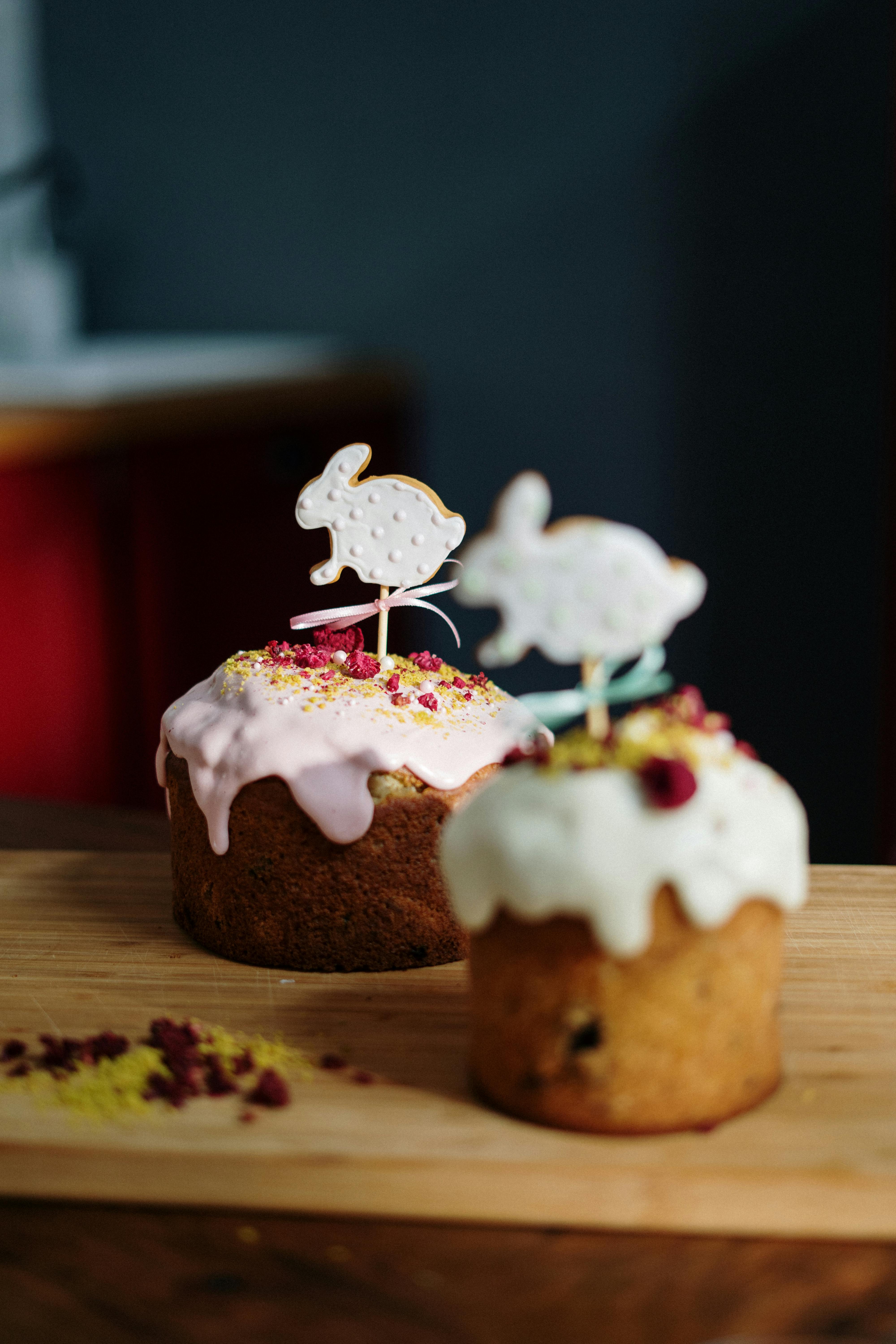 mini cakes with white icing on top and bunny topper