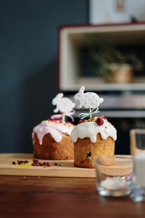 Brown Cupcake With White Icing on Brown Wooden Tray