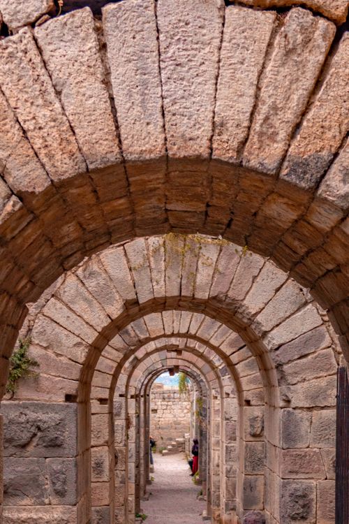 Free Stone archway leading to ancient architectural ruins, depicting historical craftsmanship. Stock Photo