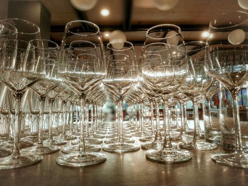 Free Crystal-clear wine glasses beautifully arranged on a restaurant table, reflecting elegance and sophistication. Stock Photo