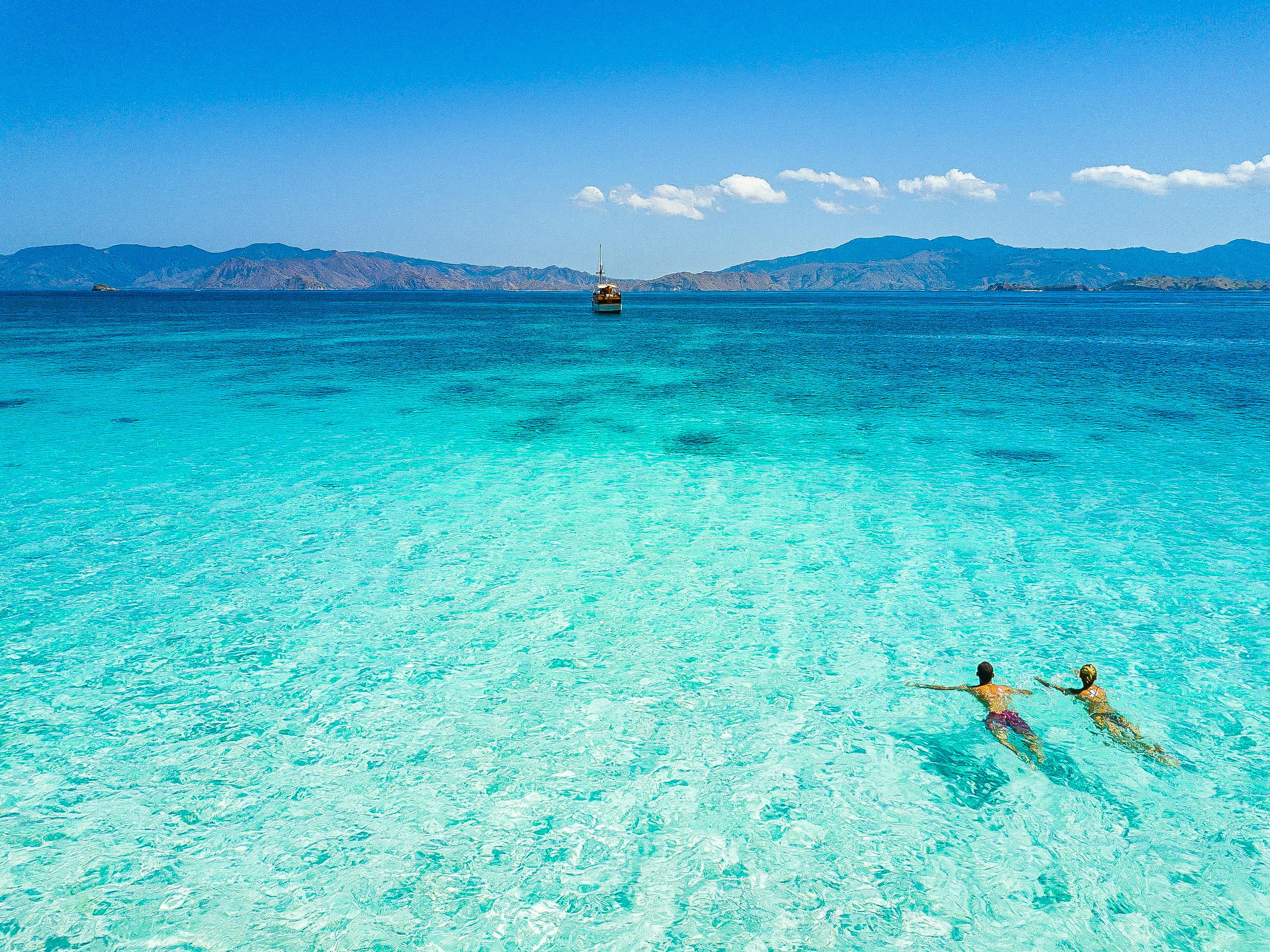 Couple Swimming In Blue Sea Under Blue Sky Free Stock Photo Couple Swimming In Blue Sea Under Blue Sky Free Stock Photo
