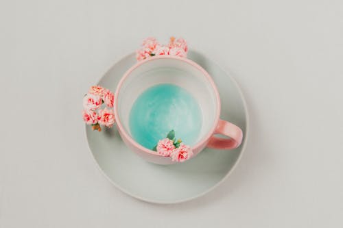 Pink Cup with Blue Liquid and Pink Flowers