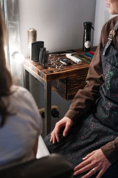 A barber's setup with tools and apron in a modern salon setting.