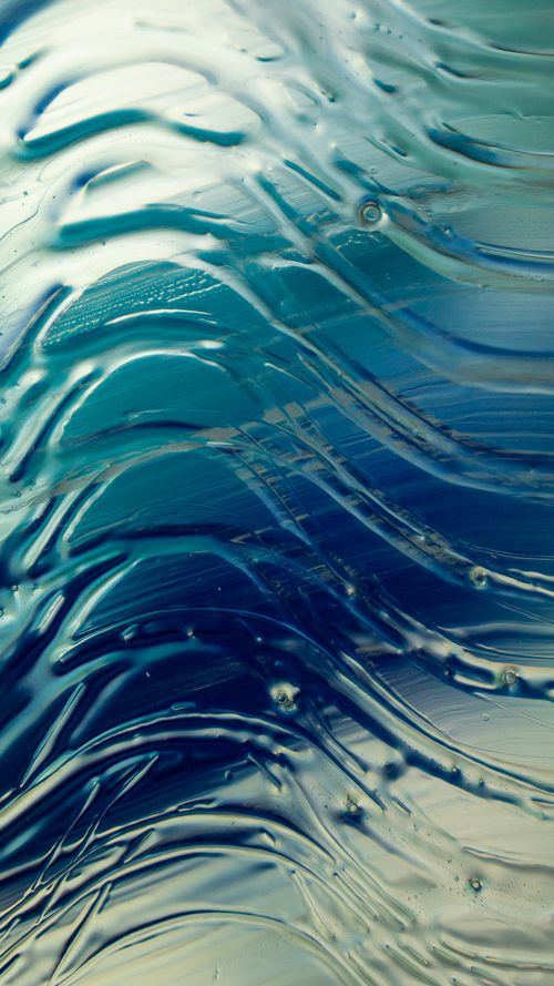 Free An abstract design featuring ocean wave patterns in blue and green glass with dynamic textures. Stock Photo