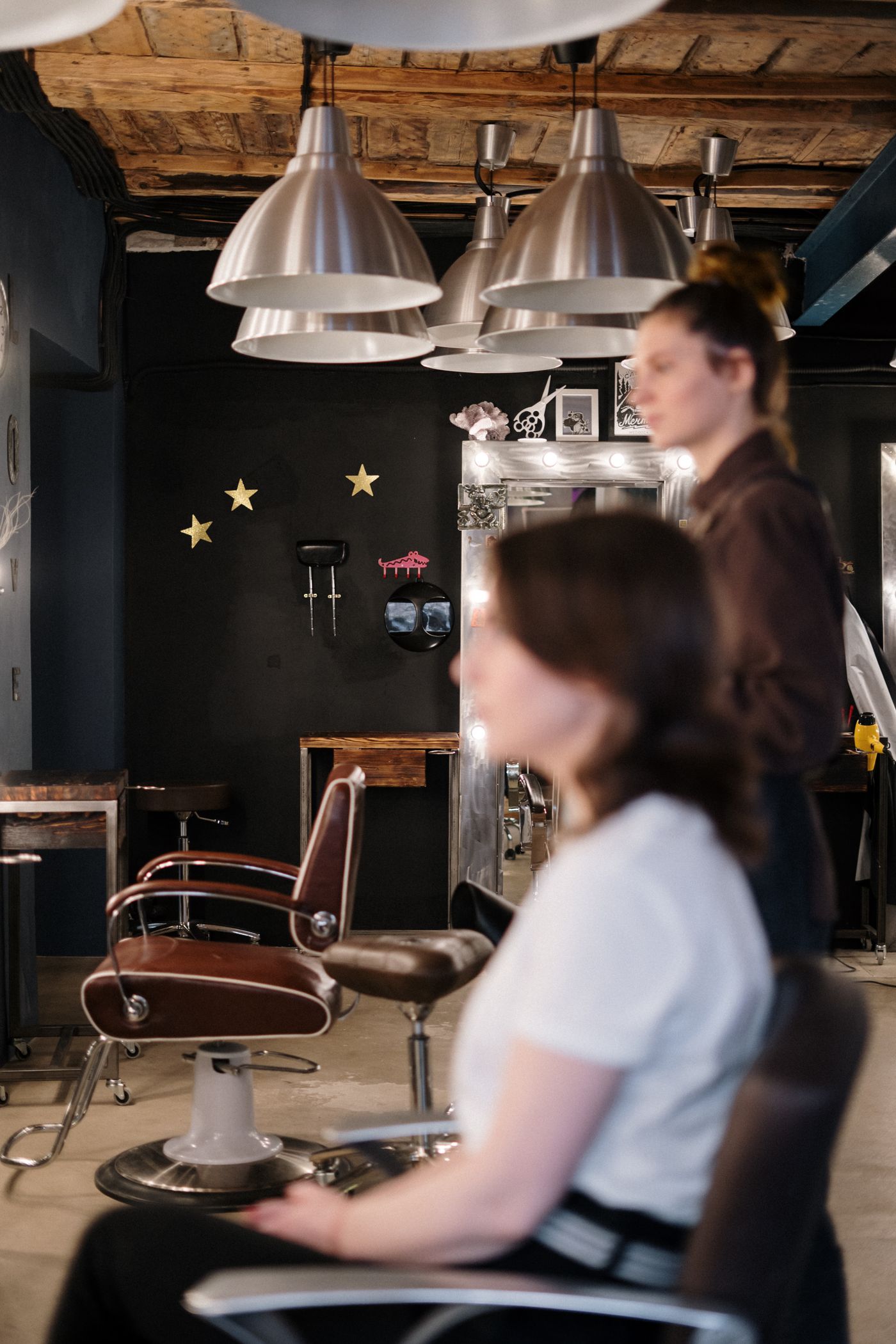 Woman receiving a precision haircut in a warm boutique salon