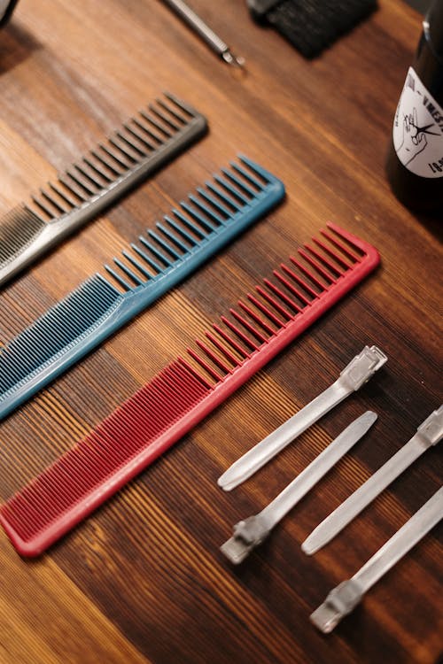 Red Hair Comb on Brown Wooden Table