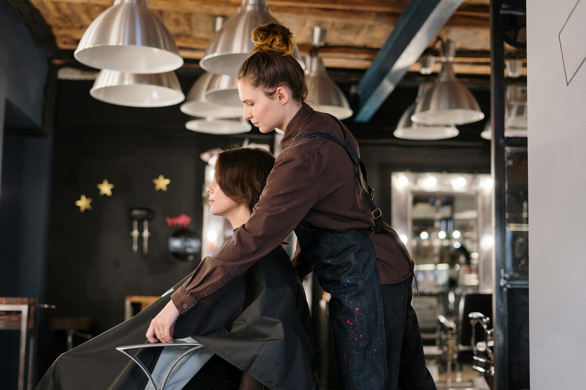 Final hairstyle results - hairdresser styling a client's hair in a contemporary salon setting. for charlie's hair and beauty