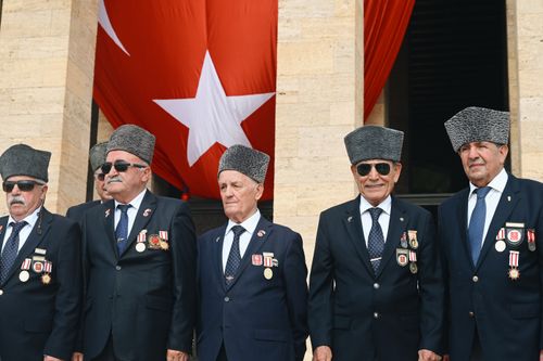 Free A group of elderly Turkish war veterans proudly standing before a large Turkish flag in Ankara. Stock Photo