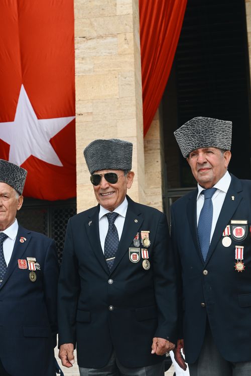 Free Turkish veterans proudly wearing medals in front of a national flag, Ankara. Stock Photo