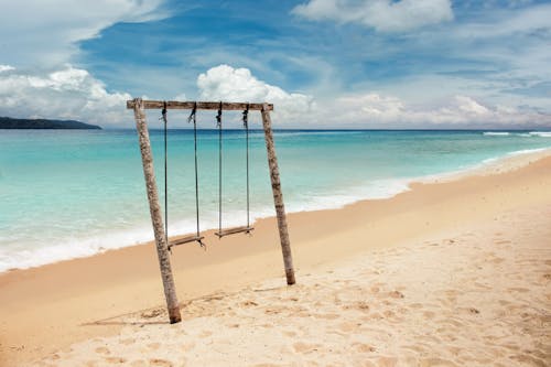 Free Brown Wooden Swing on Beach Stock Photo