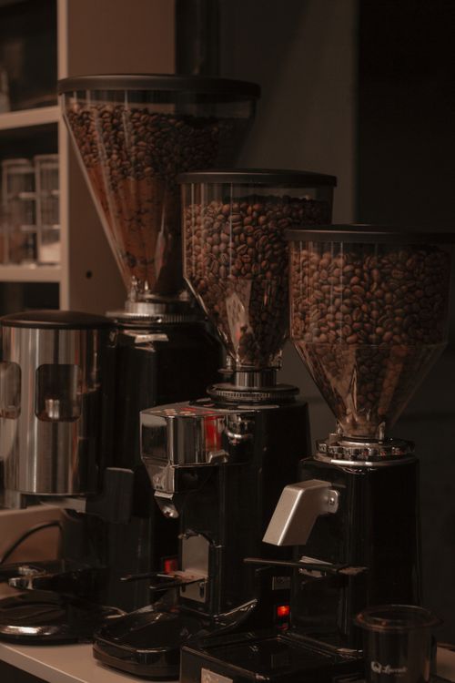 Free Row of coffee grinders filled with beans in a Kermanshah cafe setting. Stock Photo