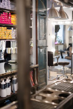 Modern salon interior featuring styling stations and colorful hair products on shelves.