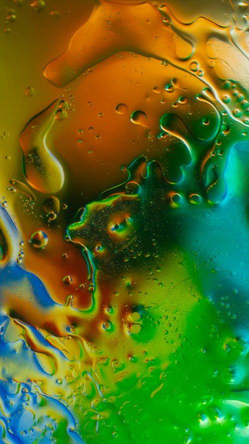 Free Vibrant abstract image featuring colorful liquid patterns in orange, green, and blue hues. Stock Photo