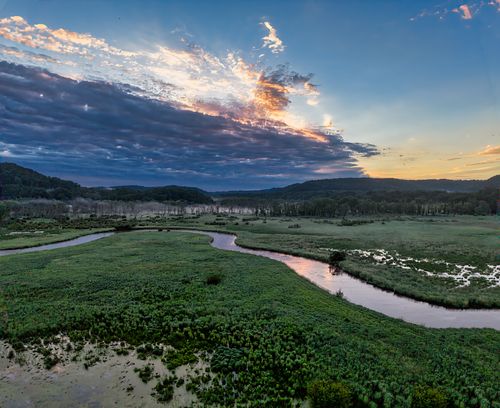 Free A breathtaking sunset over lush wetlands and a winding river in Tell, Wisconsin, USA. Stock Photo