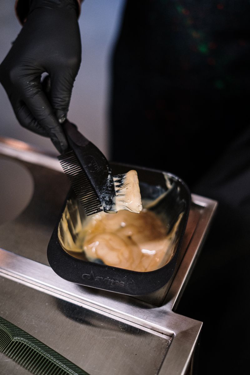 Close-up of highlight color being mixed in the salon
