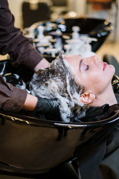 Free Person Washing Woman's Hair Stock Photo