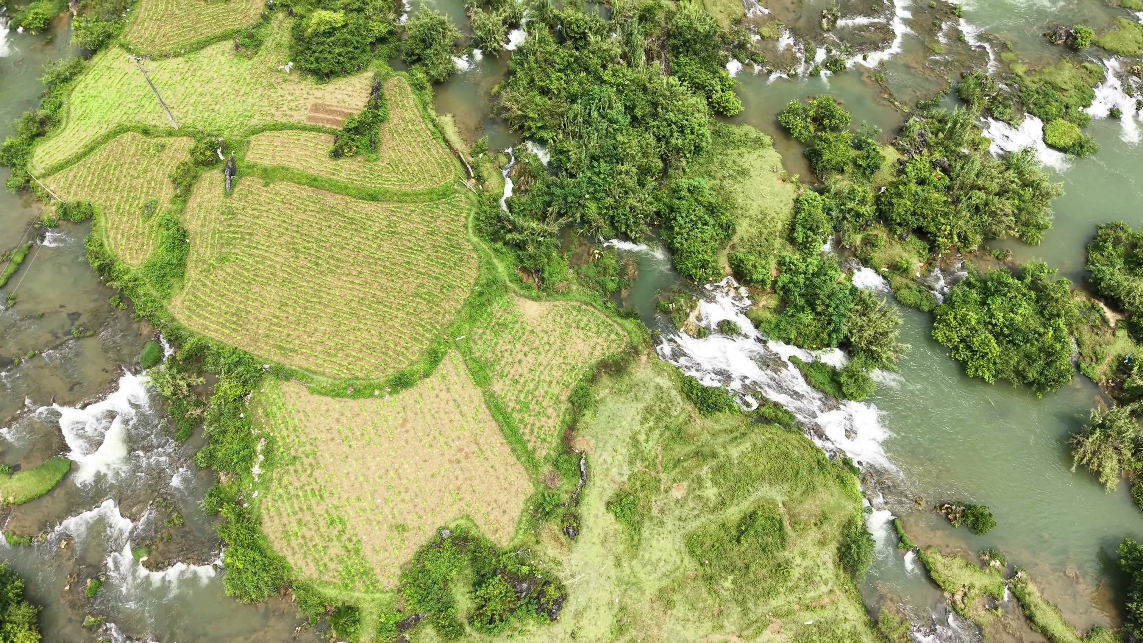 Explore vibrant rice terraces and cascading waterfalls in Doai Duong, Cao Bang, Vietnam.