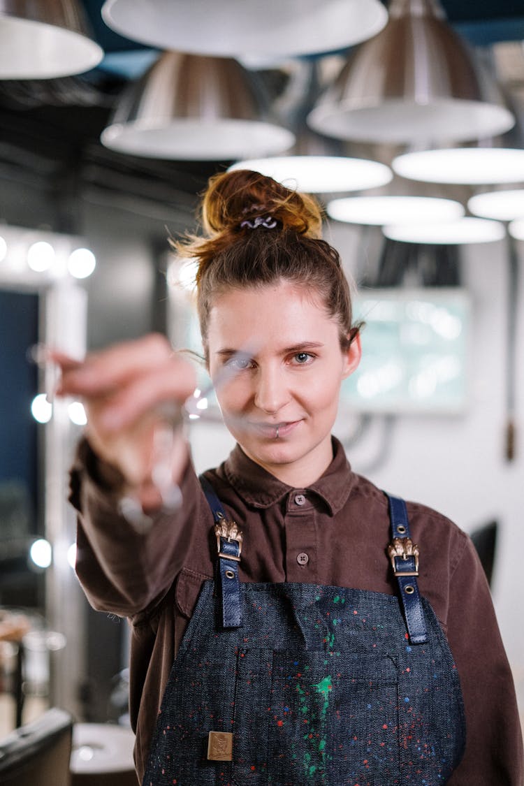 Woman In Brown Jacket Holding Silver Scissors