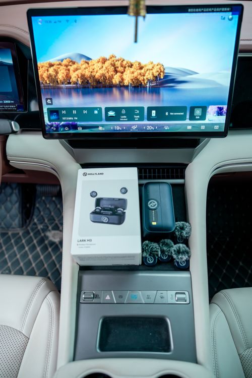 Free Modern car interior featuring a touchscreen display and wireless microphone system. Stock Photo