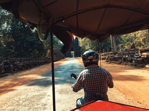 Free Experience a tuk-tuk journey through the scenic Angkor complex in Cambodia. Stock Photo