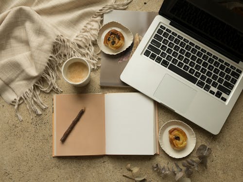 Free Macbook Pro Beside White Ceramic Mug on White Table Stock Photo